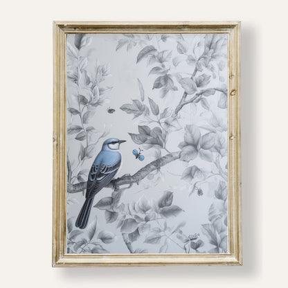 Charming blue bird perched quietly among lush green leaves
