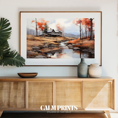 Landscape print featuring a cabin and stream in a warm autumn setting