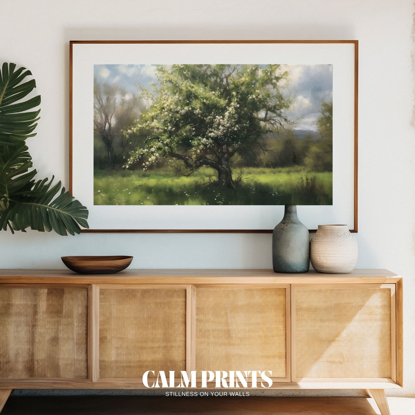 Pastel-toned tree in bloom on a gentle hillside in spring
