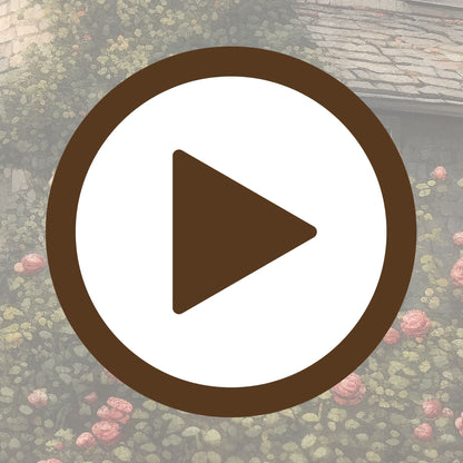 Fairytale-style cottage covered in roses and set in a lush green garden