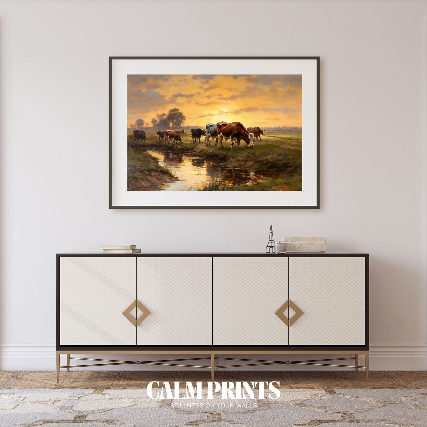 Artwork of cows by the water’s edge with sunset reflections in the stream
