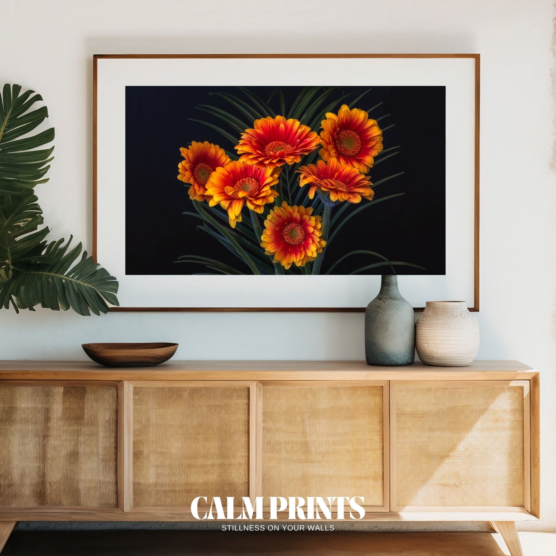 Artwork of vivid orange petals illuminated on a rich black canvas
